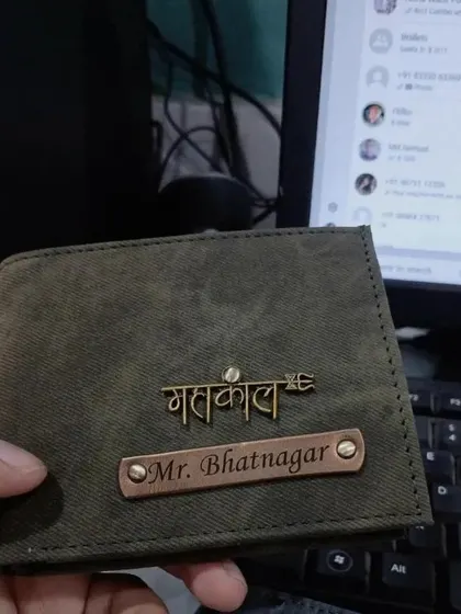 A personalized denim wallet in olive green, featuring a 'Mahakal' charm and a 'Mr.' nameplate, perfect for someone with a spiritual side.