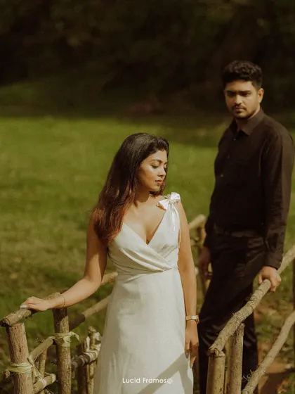 A thoughtful pose on a rustic wooden bridge, showcasing a different, more contemplative mood during a couple's shoot.