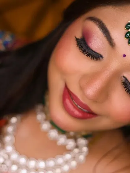 A beautiful close-up of the bride's face, showcasing her elegant makeup and serene expression.