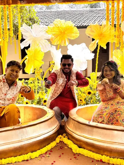 A fun pose with the couple in their Haldi tubs. I'm right there with them, making sure the fun never stops.