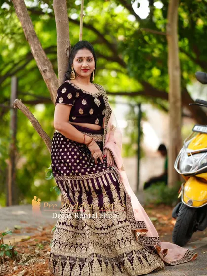 A relaxed pose in a dark velvet lehenga, showing that these grand outfits can also be styled for more casual, candid moments.