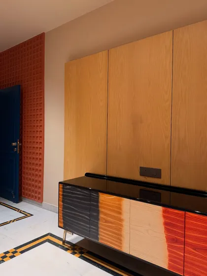 Our ombré stained console, shown here in its environment next to a bold blue door and textured wall. The piece adds a burst of color and artistic flair to the entryway.
