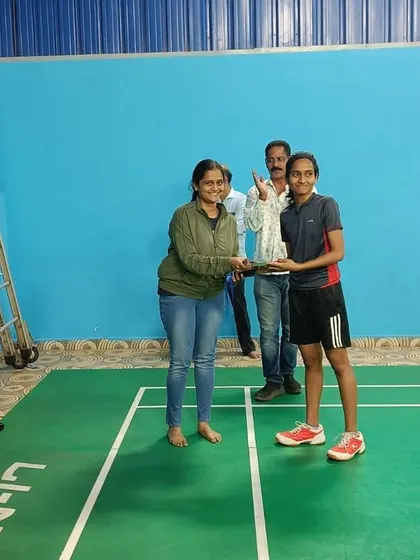 A young girl receives her trophy for winning a match in our internal tournament. These events are designed to build match temperament and confidence.