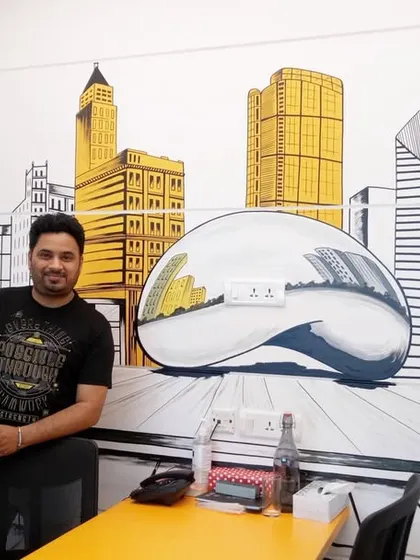 Here I am with a custom Chicago cityscape mural I painted for an office meeting room. This doodle-style art brings the city's iconic architecture, including the famous "Bean" sculpture, to life, adding a unique and personal touch to the workspace.