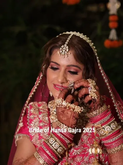 A bride adjusting her nose ring, a classic pose that draws attention to her beautiful mehendi, jewelry, and the intricate details of her bridal look.
