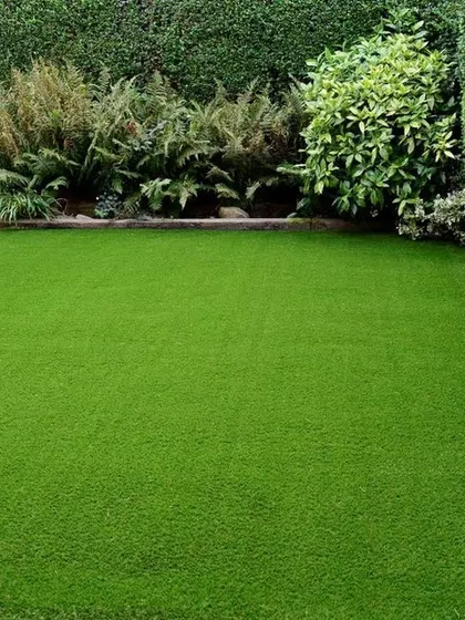This installation shows a seamless stretch of artificial grass right up to a natural hedge. My work ensures a clean edge and a consistently lush look that enhances the entire garden space.