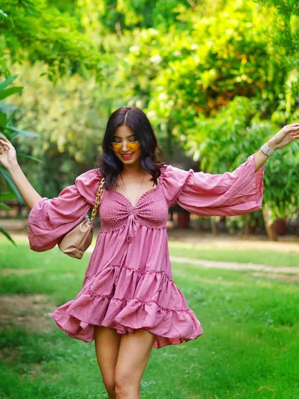 Another beautiful twirling shot, capturing the ruffles and movement of the pink dress in a moment of pure fun.