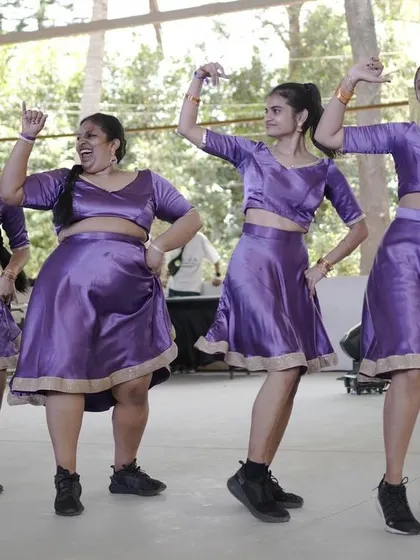 A group of dancers in purple costumes, performing at Spectra.