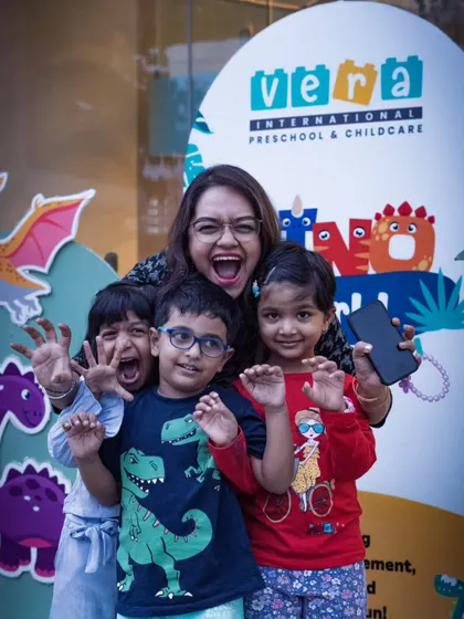 A group of happy kids and their teacher posing at a Dino Carnival photo booth. Capturing the collective joy and excitement of an event is one of my favorite parts of the job.