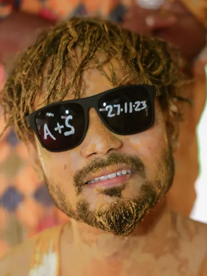 A cool groom portrait after the Haldi ceremony, with the wedding date written on his sunglasses. It's all about those fun, personal details.
