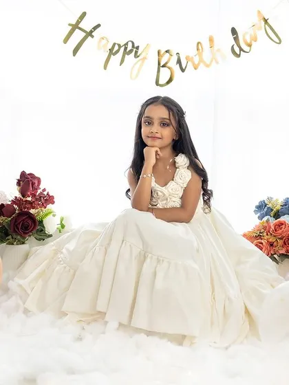 A dreamy and elegant portrait for a seventh birthday. The soft, cloud-like floor and beautiful gown create a fairytale atmosphere.
