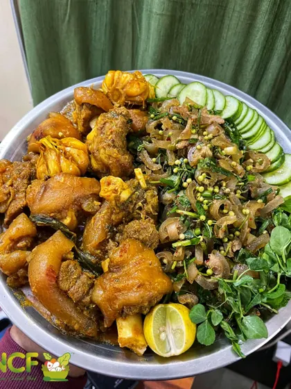 A hearty platter of pork trotters served alongside a spicy pork skin singju.