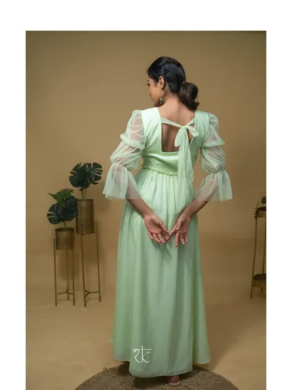 The back of the dress features a simple tie-up bow, adding a charming and feminine detail.
