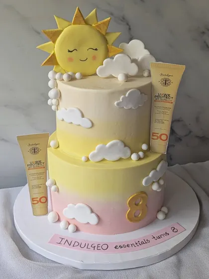 I created this two-tier cake to celebrate the 8th anniversary of Indulgeo Essentials and the launch of their new sunscreen. It features a soft, sky-like buttercream finish and fully edible replicas of the product, turning a brand milestone into a delicious work of art.