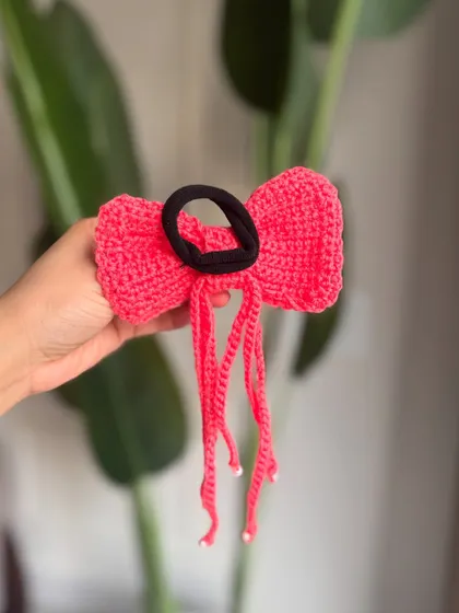 The back view of our tassel bow, showing the sturdy hair tie that keeps it securely in place.