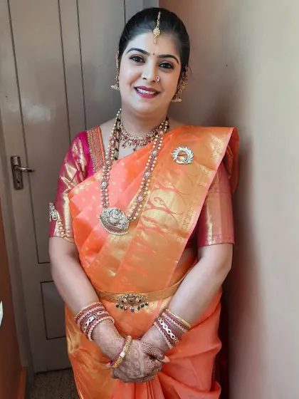 A happy client ready to welcome guests to her new home. The soft, warm makeup tones enhance her natural glow.
