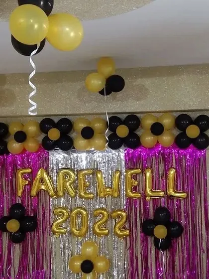 Another angle of the farewell party decor, showing how the balloon arrangements extend to the ceiling to create a more filled and festive look for the occasion.