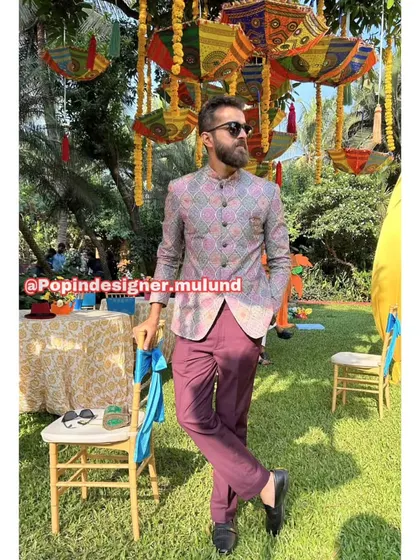 A solo shot of the client in the printed Jodhpuri jacket. The vibrant colors and patterns are perfect for a festive, celebratory atmosphere.