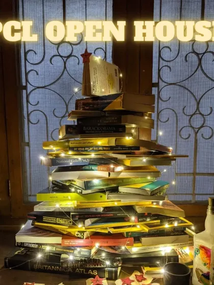 An invitation to our Open House, featuring our Christmas tree made of books. A perfect time to check out the lab.