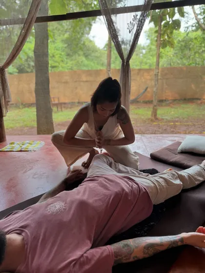 Practicing a leg and hip opening stretch during my Thai massage course. This technique helps release the psoas and improve flexibility in the lower body.