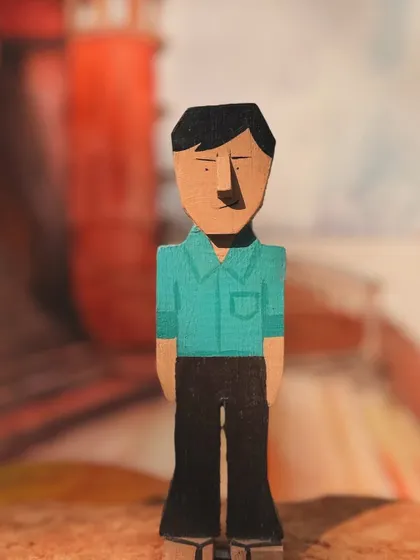 This is the Topshe figurine, Feluda's loyal and observant cousin. His simple and straightforward design reflects his role as the reliable narrator of their adventures.