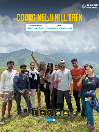 A group of friends on the Coorg Nelji Hill trek, with beautiful mountains in the background.