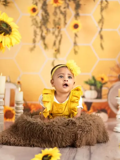 A moment of wonder captured in our sunflower-themed setup. This tummy-time shot is perfect for younger babies, highlighting their strength and curiosity.
