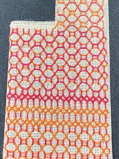 The finished phone insert with a gradient pattern in shades of orange and pink.