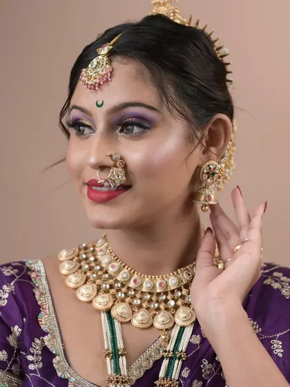 A student's exam day work, showing a colorful and creative Maharashtrian bridal look with purple and yellow eyeshadow.