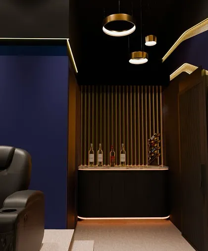 Every part of the theater is an experience. This project included a custom-designed bar and refreshment area, seamlessly integrated into the overall aesthetic with matching lighting and materials.