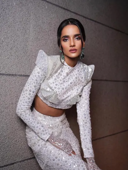 A high-fashion, futuristic look with a sequined white outfit. This is an example of the creative portfolio work we do, teaching you to think outside the box and develop your unique artistic signature.