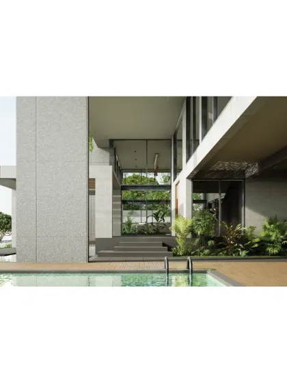 A view from the pool deck of the 'House on Water', looking back into the transparent ground floor living area. The design erases the boundary between inside and out, allowing the home to feel like an open pavilion within a garden.