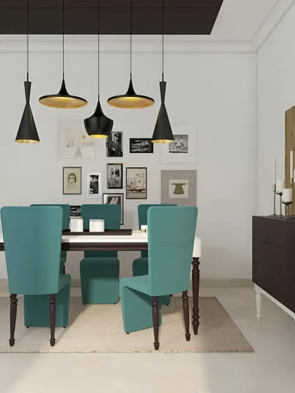 A contemporary dining room with a fun, eclectic vibe. The gallery wall of photos, mismatched pendant lights, and bright teal chairs give the space a lot of personality.