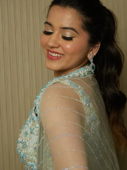 A happy and glowing look created by a student, featuring a shimmery eyeshadow and a high ponytail.