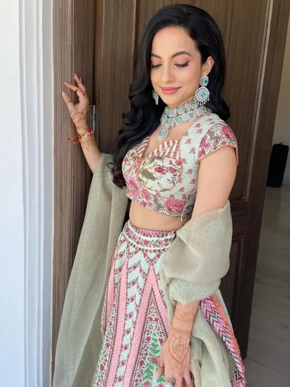The soft waves add a touch of romance without overpowering the intricate details of the bride's outfit and accessories.