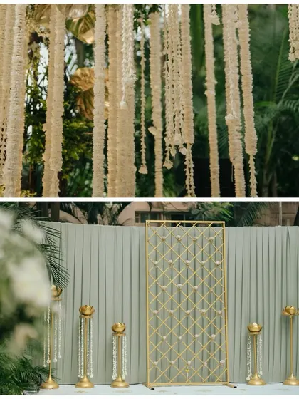 A closer look at the decor elements, showing the contrast between the traditional hanging floral strings and a modern, geometric gold screen, illustrating our ability to blend different styles.