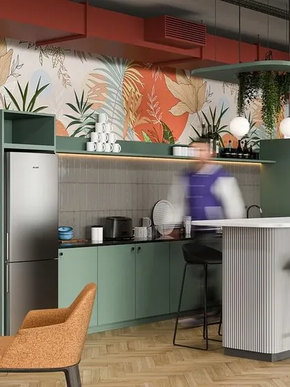 A vibrant office pantry designed to be a hub of activity. The space features green cabinetry, a breakfast bar, comfortable seating, and a botanical wallpaper that adds a playful and energetic touch.