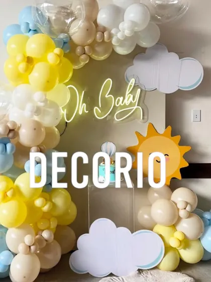 A cheerful and bright baby shower setup with a "You are my sunshine" feel. I used a yellow, blue, and white balloon arch, cloud and sun cutouts, and an "Oh Baby" neon sign to create this happy display.