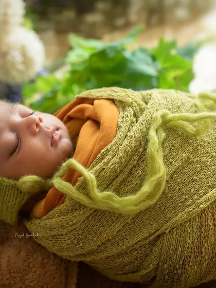 Another angle of this peacefully sleeping newborn, showing the careful wrapping and posing that keeps the baby comfortable and creates a beautiful, organic look.