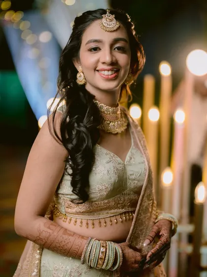 A beautiful portrait of the bride, Zaee, at her Sangeet, her smile lighting up the frame.