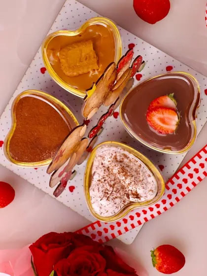 A top down view of the four heart shaped desserts in our Teddy Love box: Tiramisu, Banoffee Pie, Belgian Chocolate Mousse, and Lotus Biscoff Cheesecake.