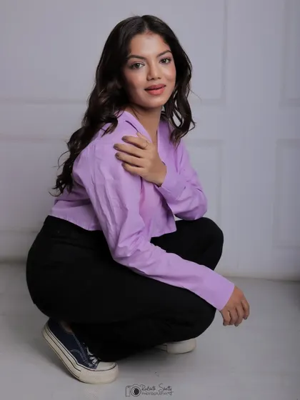 A casual and modern portrait for a model's portfolio. The simple studio background and clean lighting put all the focus on her relaxed pose and natural expression, showcasing her versatility.