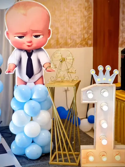 A large light-up number '1' and a Boss Baby cutout make for a great photo spot at the party.
