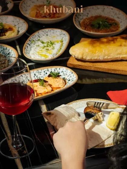 Savor every bite, sip, and moment. A table laden with Turkish mezzes, fresh pita, and wine is where artistry meets fine dining.