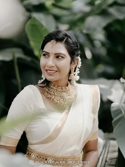 A lovely portrait of the bride-to-be, framed by large green leaves, creating a natural and beautiful composition.