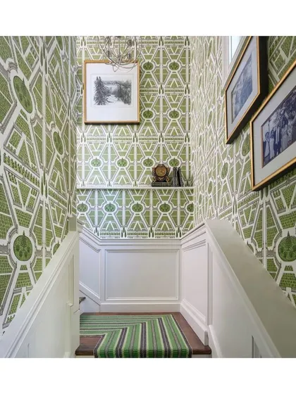 The combination of a geometric wallpaper and a striped stair runner creates a huge impact in this stairwell. It's a dose of serious design inspiration on how to treat transitional spaces with importance.