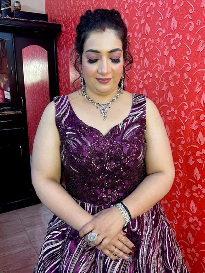 Another beautiful shot of the client, showcasing the full effect of the hair, makeup, and outfit.