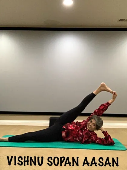 Vishnu Sopan Aasan, a reclining leg stretch, is an advanced posture that demonstrates deep hamstring and hip flexibility. It's a goal to work towards with a consistent practice.
