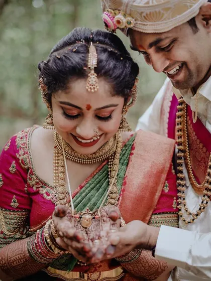 It’s moments like these that make my work so rewarding. This candid shot captures the bride's joy, wearing a custom-designed blouse with intricate hand embroidery that beautifully complements her wedding saree.
