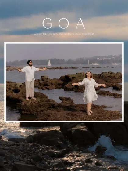 "GOA: Where the sun, sea, and serenity come together." A beautiful landscape shot of the couple on the rocks, with arms outstretched, embracing the freedom and beauty of the coast.